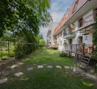 The courtyard in Piešťany on Orviský Kút Street is lined with gardens and apartment balconies.
