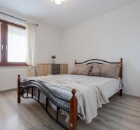 A bedroom with a metal bed and a wooden decor floor in a 2-room apartment.