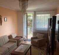 Living room in a 3-room apartment with comfortable seating and balcony doors.