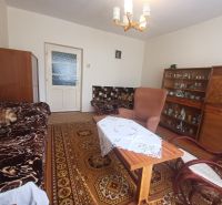 Living room of a family house with retro furniture and a patterned carpet.