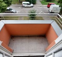 A balcony from a 2-room apartment on 28. októbra Street in Trenčín with a view of the street.