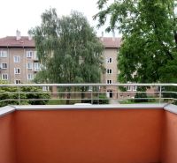 The balcony of a 2-room apartment on 28. októbra Street in Trenčín with a view of greenery.