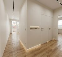 Interior of a 3-room apartment with a wooden decor floor and large windows.