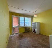 A room in a 3-room apartment with a wooden decor floor, yellow walls.