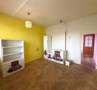 Children's room in a 3-room apartment with a wooden decor floor and yellow walls.
