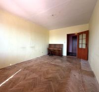 A room in a 3-room apartment with a wood-patterned floor and a piano.