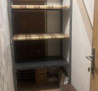 A storage room with shelves and a floor with a wooden decor in a 3-room apartment.