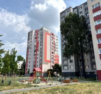 In Bratislava on Andrusovova Street, there are apartment buildings surrounded by a playground and greenery.