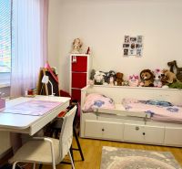 Children's room with wood-decor flooring, a desk, and toys in a 3-room apartment.