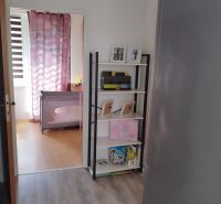 Interior of a 2-room apartment with a shelf and a wooden decor floor.