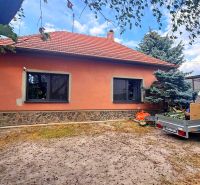 A family house in Iža with a spacious yard and a carport.