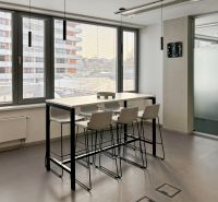 Glass table, high chairs, large windows, offices.