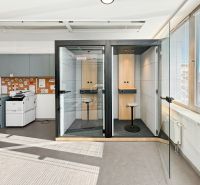 Offices with phone booths and a printer, simple interior with glazing.