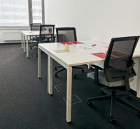 Offices with desks and chairs, ready for work.
