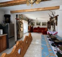 Rustic living room in a family house with decorations and wooden elements.