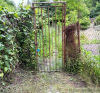 A rustic gate leads to the garden at the cottage in Bratislava IV.