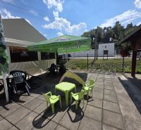 Exterior of commercial premises in Divín, terrace with a sunshade and children's corner.