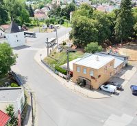 Aerial view of commercial premises in Divín surrounded by greenery and historic buildings.