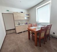 A kitchen corner with a wooden decor floor and a dining table in commercial premises.
