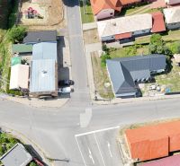 Aerial view of commercial premises in Divín with adjacent roads and greenery.