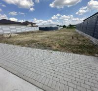 A residential plot in Lučenec offers a spacious grassy area next to the paving.