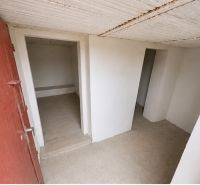 Interior of a cabin with light walls and multiple rooms, floor with wood decor.