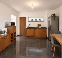 A kitchen in a family house with a wooden decor floor and stainless steel appliance.