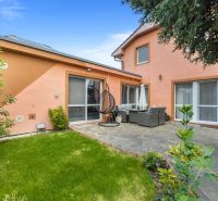 A family house in Bernolákovo with a terrace, garden furniture, and a view of a well-maintained lawn.
