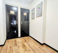 Black doors, white walls, wooden decor flooring in dining areas.