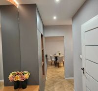 Interior of a 2-room apartment with a wooden decor floor and elegant details.