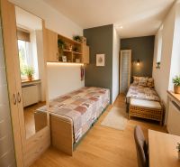 Children's room with two beds in a 3-room apartment, floor with wooden decor.