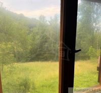 View from a family house in Kokava nad Rimavicou of green trees and meadows.