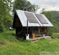 A family house in Kokava nad Rimavicou surrounded by nature, with solar panels on the roof.