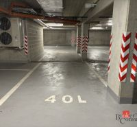 Underground garages with marked spaces, concrete pillars, and air conditioning.