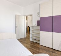 A room in a 3-room apartment with a bed, a wardrobe, and a wooden-decor floor.