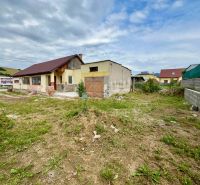 A family house in Ľubotín with a yard, nearby neighboring properties, with hills in the background.