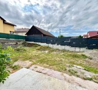 A family house in Ľubotín with a fenced plot, grassy area, and neighboring houses.