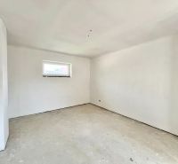 A spacious room with white walls in a family house ready for decoration.