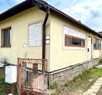 A family house in Ľubotín with a plastered facade and tiled finishes around the windows.