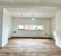 Interior of a family house with a wooden decor floor and preparation for electrical installation.