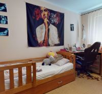 Children's room in a 3-room apartment with a bed, decorations, and a desk.