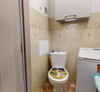 Bathroom in a 3-room apartment with a washing machine and toilet, decorated with tiles.