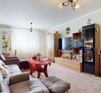 Living room in a 3-room apartment with a comfortable sofa and a decorative wall.