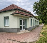 Single-story production facilities in Diakovce with a red tile roof and paved flooring.