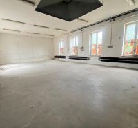 Production spaces with a minimalist interior, white walls, and gray floor.