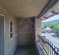 A balcony with a view of the street and surrounding nature in Ružiná, family house.