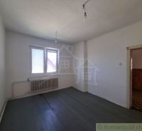 A room with a wooden decor floor and a radiator in a family house.