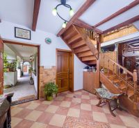 Interior of a family house with wooden stairs and a floor with a wooden decor.