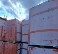 Building material on residential plots in Tešedíkovo near the buildings.