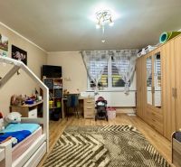 Children's room in a family house with a wooden decor floor and furniture.